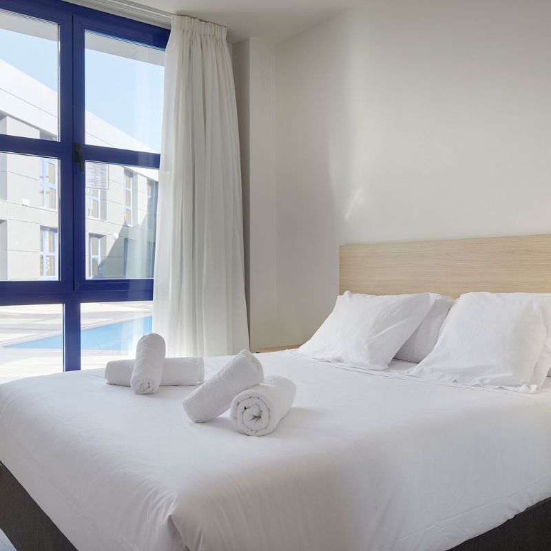 Room with large bed and pool view