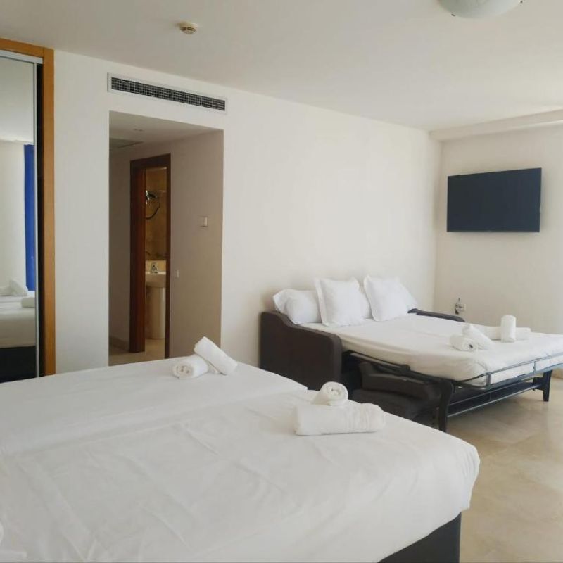 Room with twin beds and sofa bed